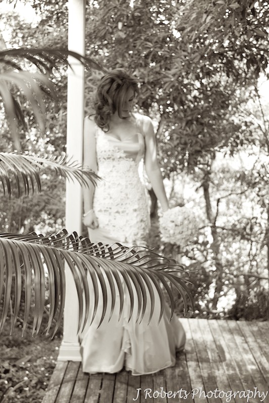 Sepia bride looking down at flowers - wedding photography sydney